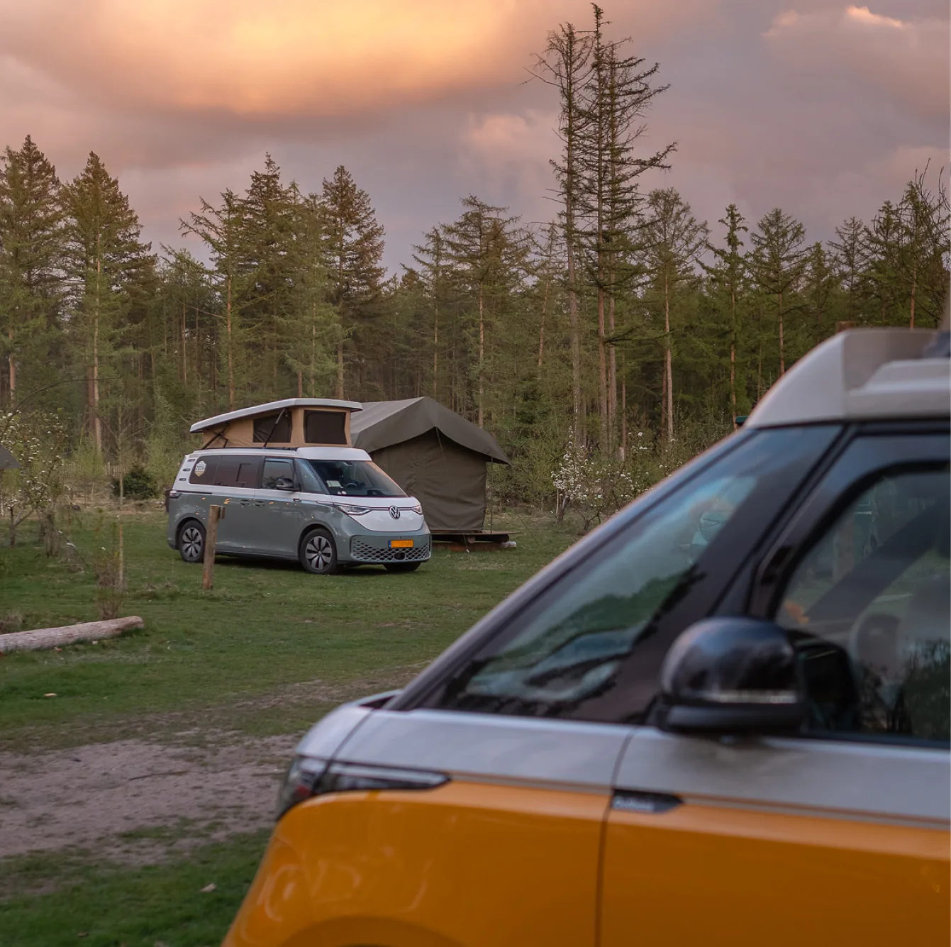 Outbase campervans at a camping spot at sunset