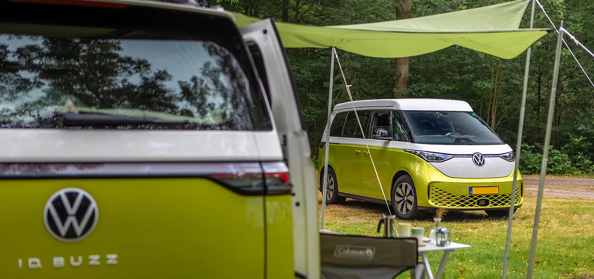 Outbase ID Buzz campervan with awning at a camping spot