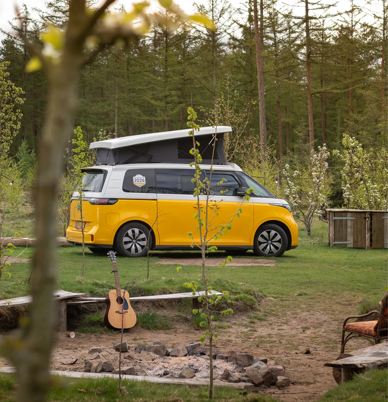 Yellow Outbase campervan at a camping spot