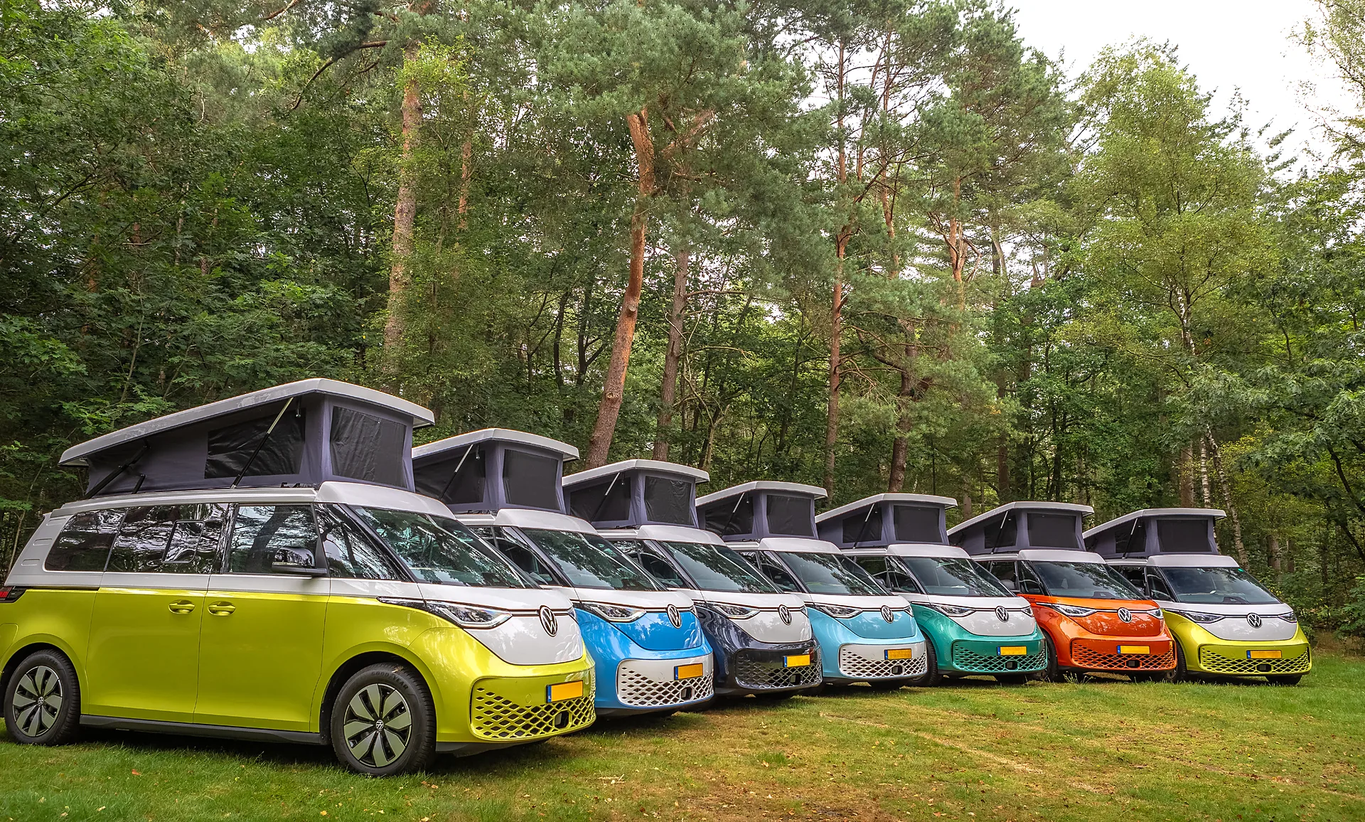 Colourful fleet of Outbase ID Buzz campervans with open pop tops