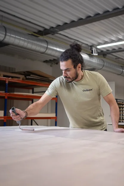 Medewerker werkt aan een houten paneel in de werkplaats